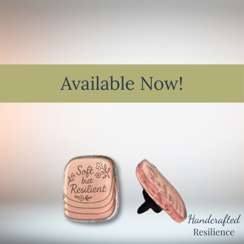 Handcrafted resilience pink pin with 'Soft but Resilient' text on a gradient background